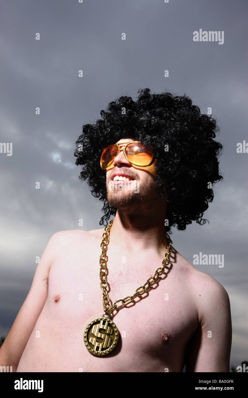 Funny guy with afro wig glasses and bling Stock Photo