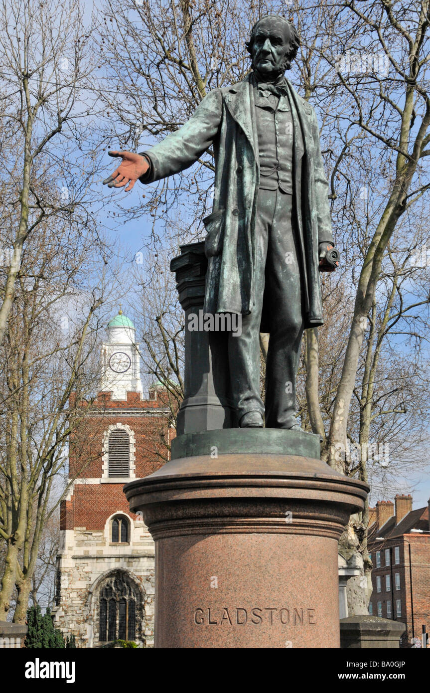 Historical statue commemorating William Gladstone outside The Church of St Mary Bow hands daubed with red paint Tower Hamlets East London England UK Stock Photo