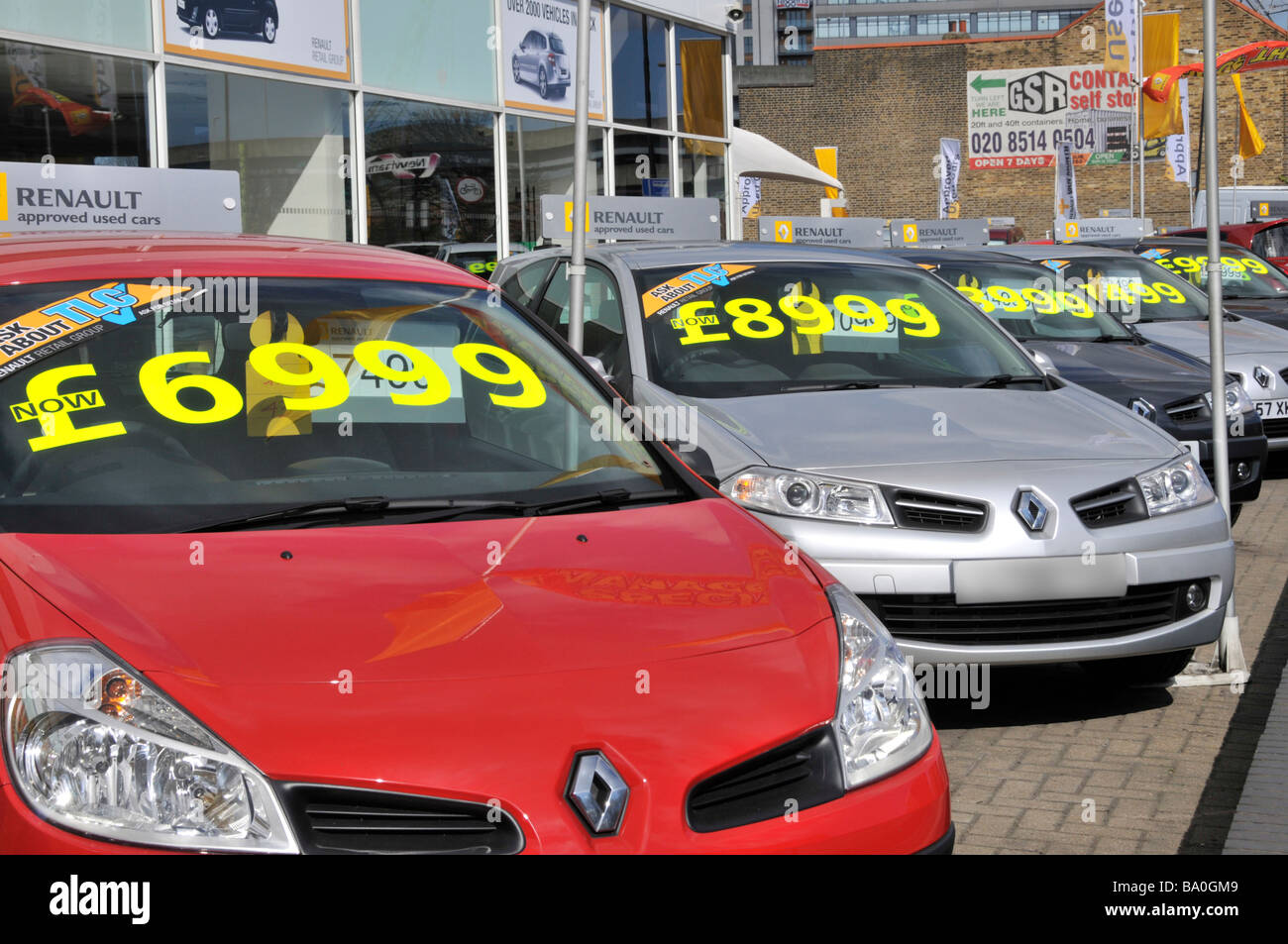 Ilford East London Renault used second hand car dealership forecourt display row in line of dealer cars with clearance sale price tag label England UK Stock Photo