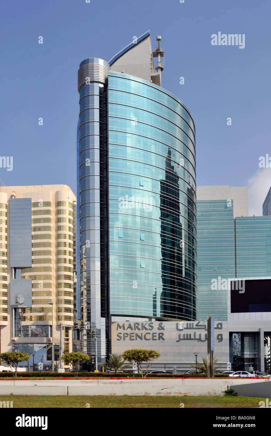 Modern architecture building high rise block towering above Marks and Spencer bilingual retail business store sign Abu Dhabi UAE Middle East Asia Stock Photo