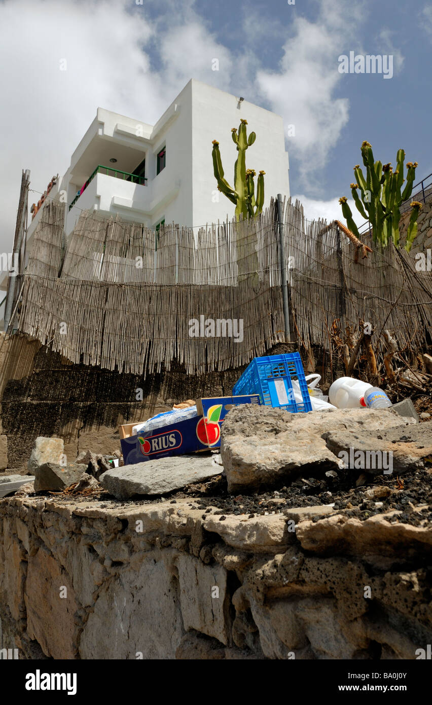 The waste management in the Puerto Rico. Just throw trash over the fence. Puerto Rico, Gran Canaria, Canary Islands, Spain, ... Stock Photo