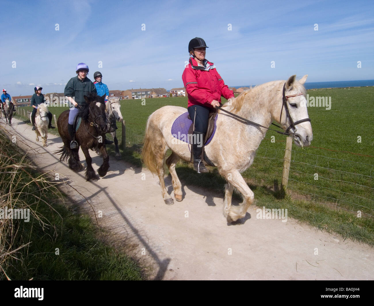 Horse riders from a local riding school on a bridleway at Saltburn Cleveland UK Stock Photo