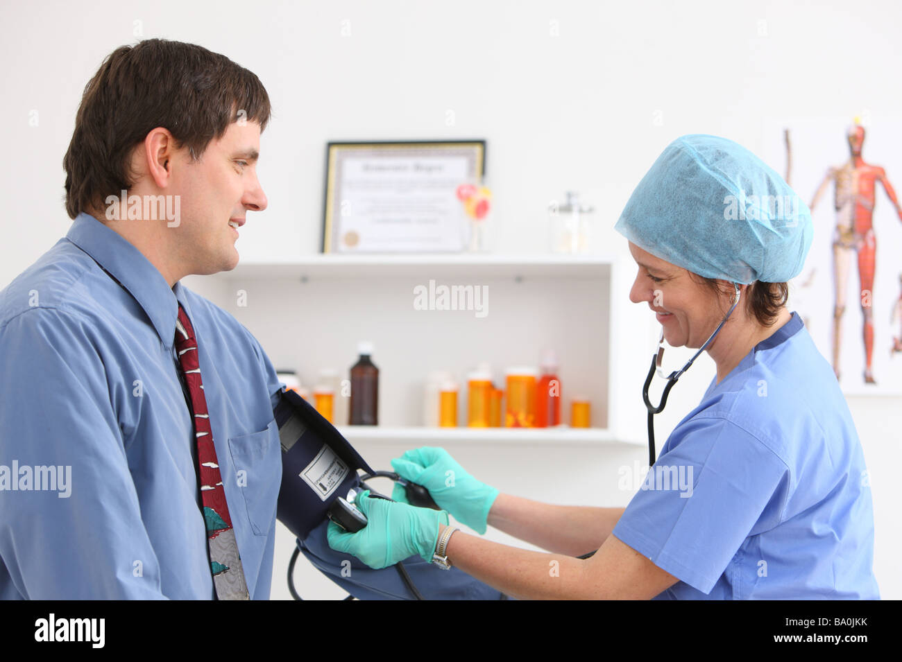 Man getting blood pressure taken at doctors office Stock Photo