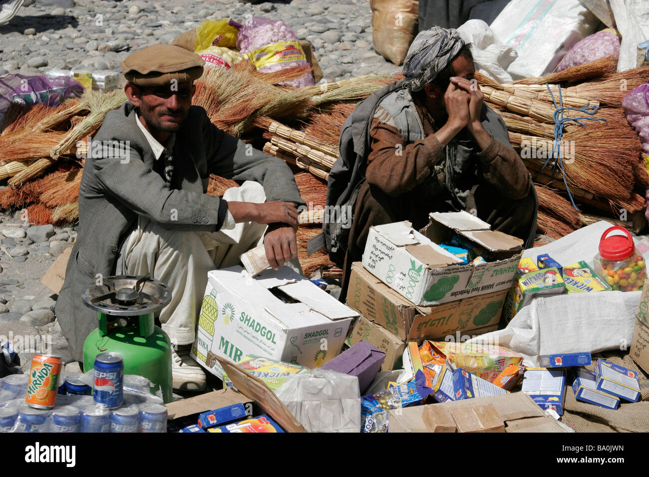 Afghan men wearing traditional hat on the transborder market near Ishkashim on the border between Tajikistan and Afghanistan Stock Photo