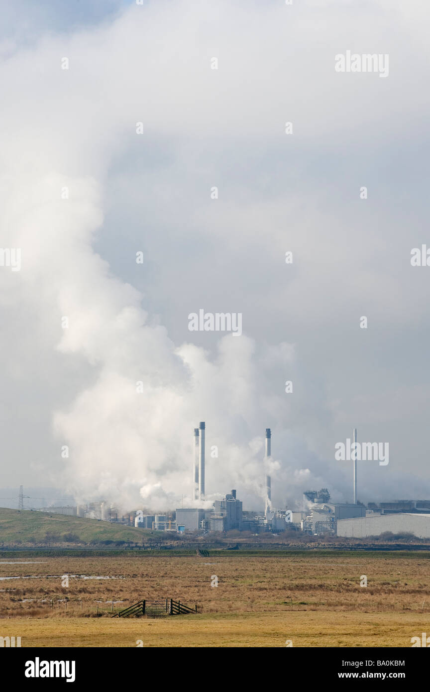 Paper mill and emissions mixing with clouds From Elmley Marshes Kent UK Stock Photo