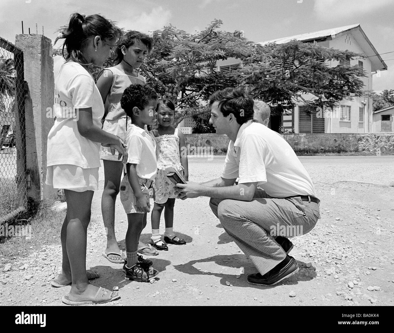 Catholic missionary worker talking to children Corozal, Belize, Central America Stock Photo