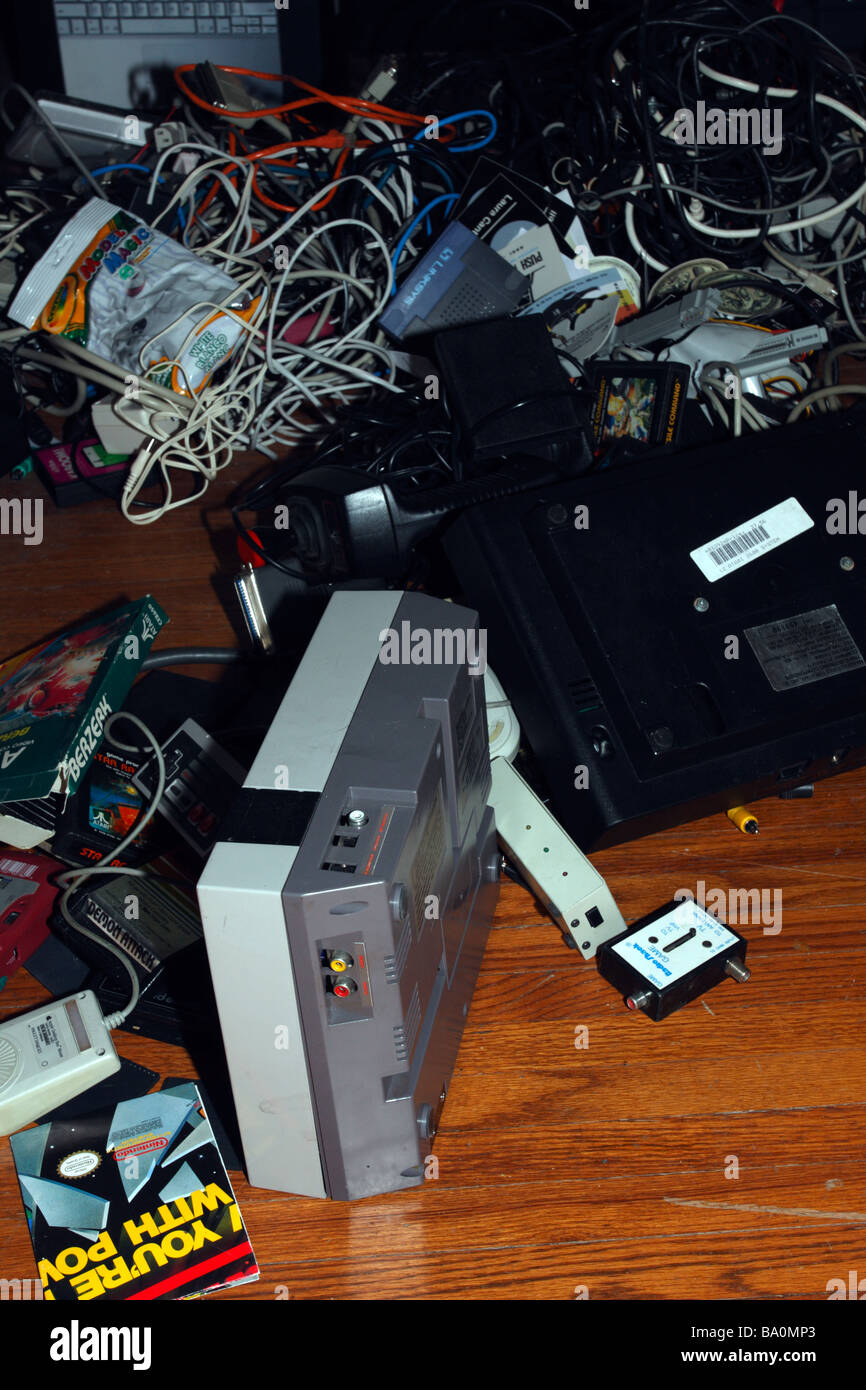 Assorted video game consoles, controllers, and cartridges. Stock Photo