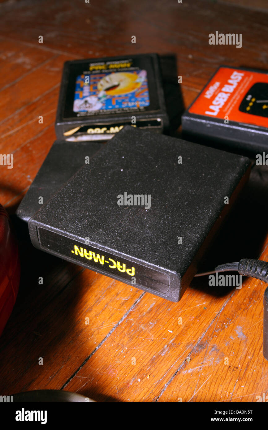 Atari PAC MAN game cartridges and wood floor. Stock Photo