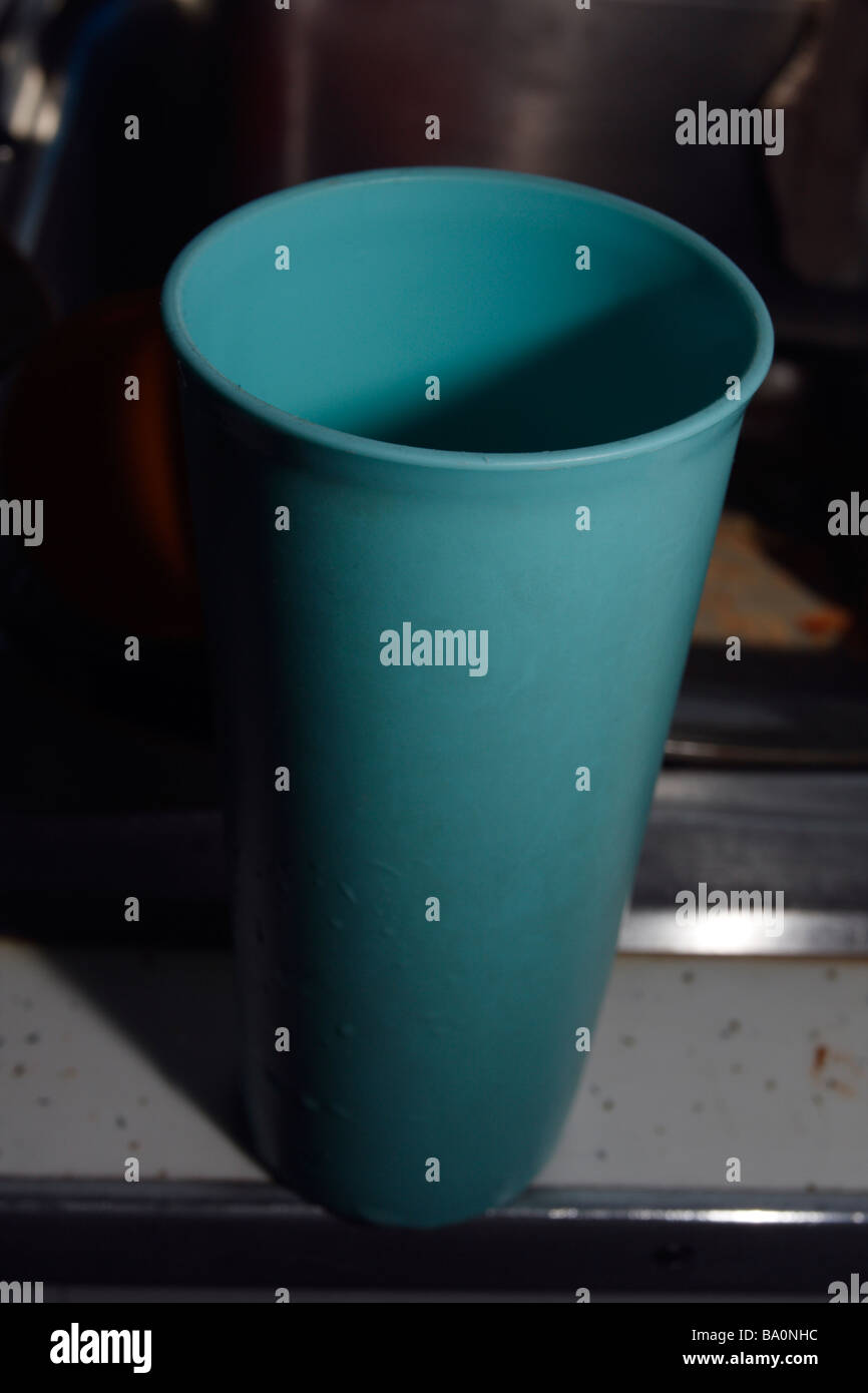 https://c8.alamy.com/comp/BA0NHC/aqua-blue-green-tupperware-drinking-glass-dark-BA0NHC.jpg