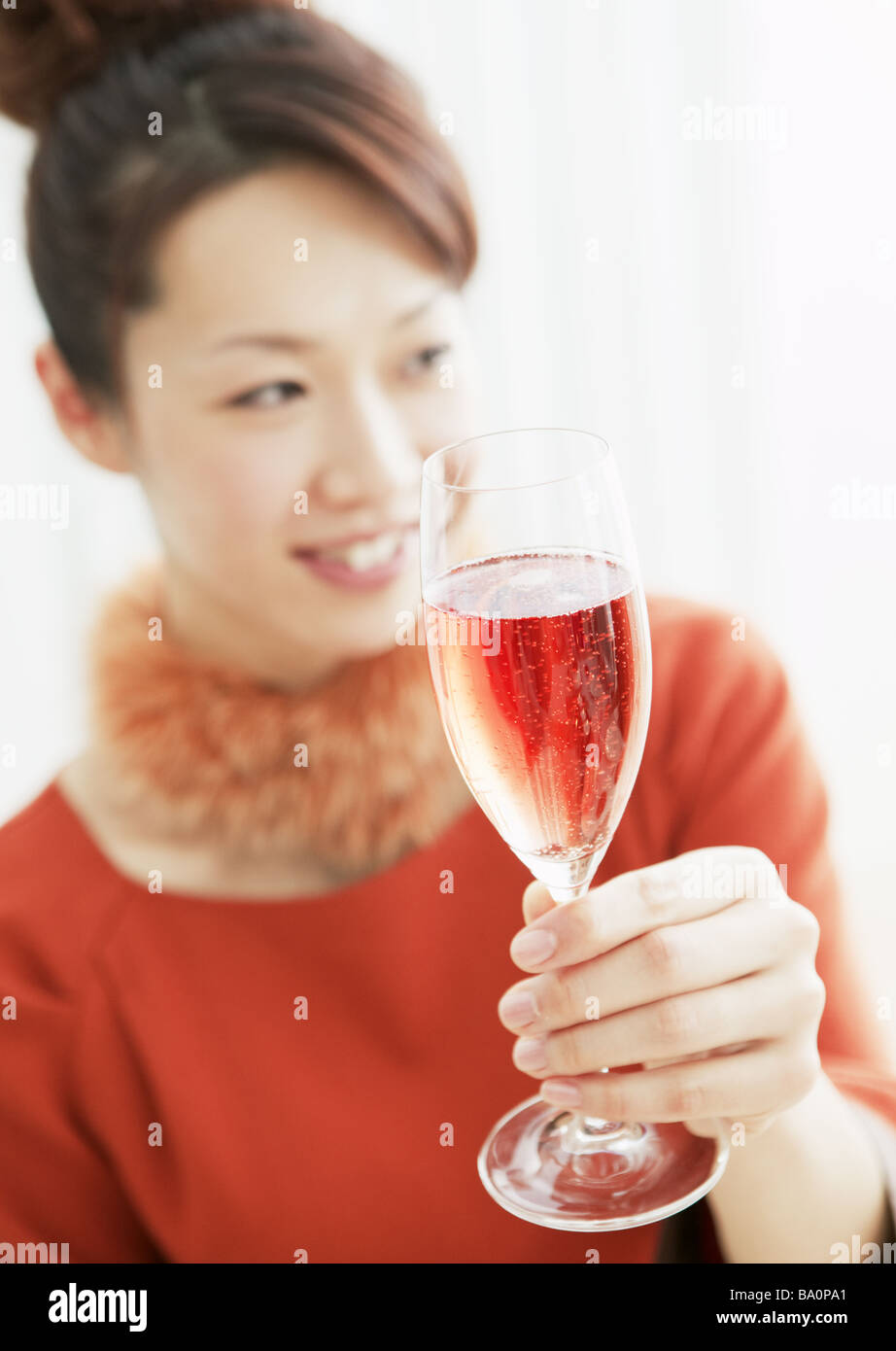 Woman holding a glass of champagne Stock Photo