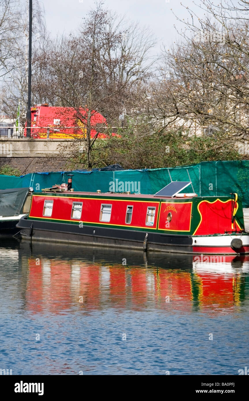Bright red barge, blue water reflection and Royal Mail van on a bridge at Grand Union Canal, Paddington Basin, London, UK, Europ Stock Photo