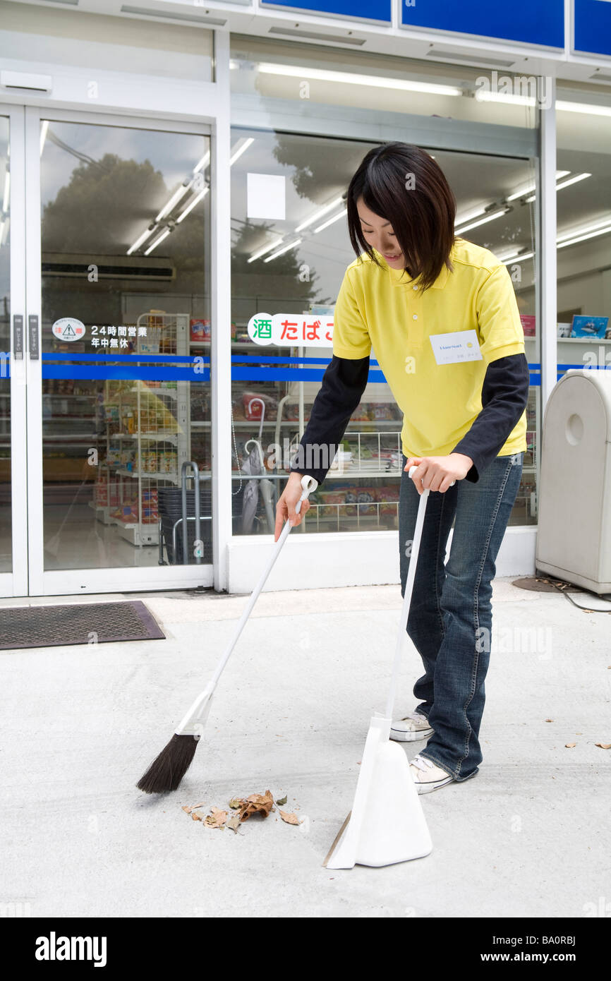 Convenience store clerk cleaning up store Stock Photo Alamy