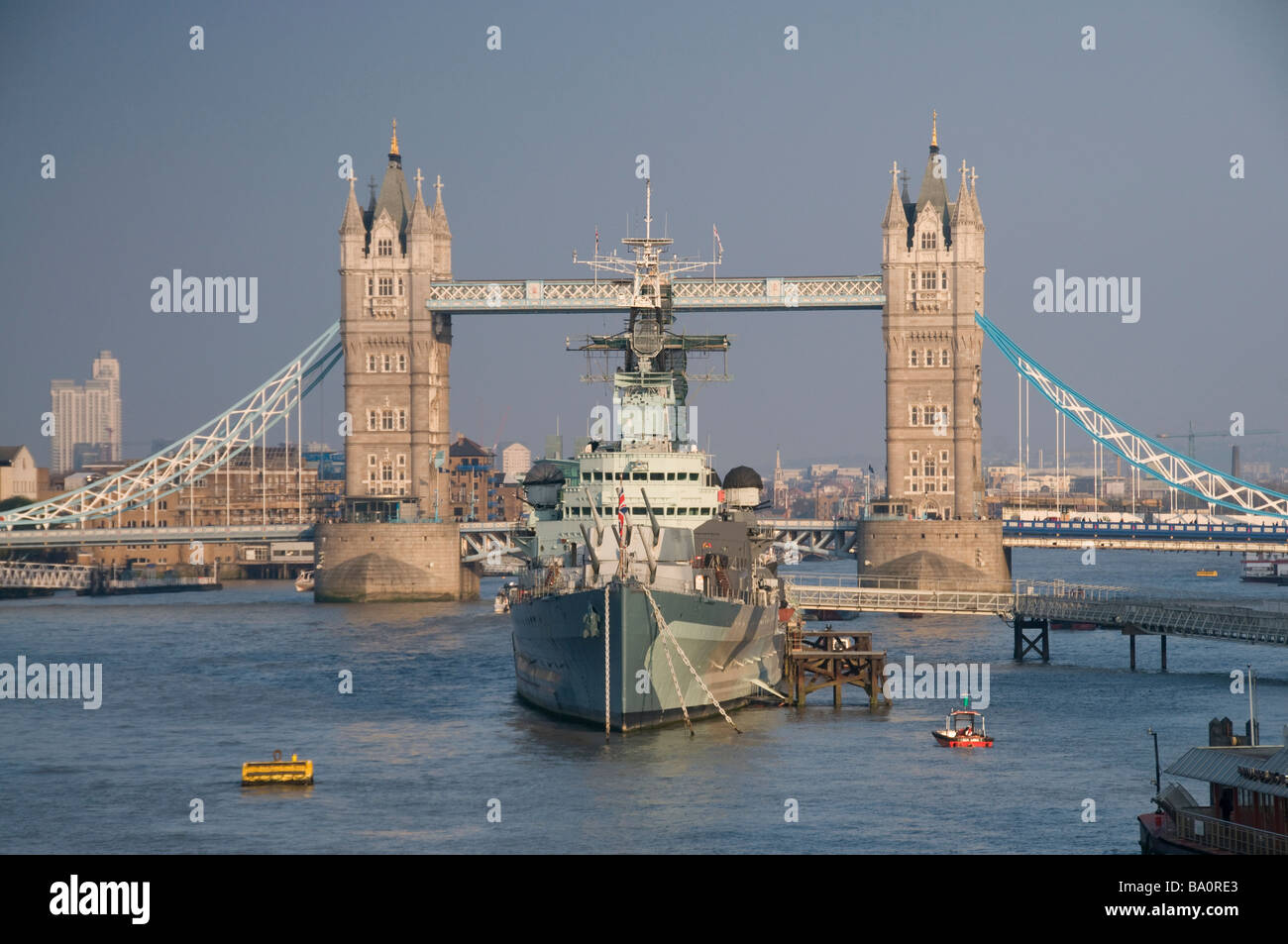 Warship HMS Belfast anchored by Tower Bridge, Southwark, London, England Stock Photo