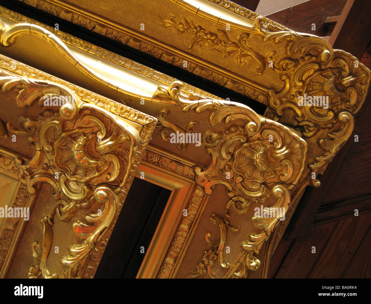 Right angle corners of three ornate antique gilded picture frames Stock