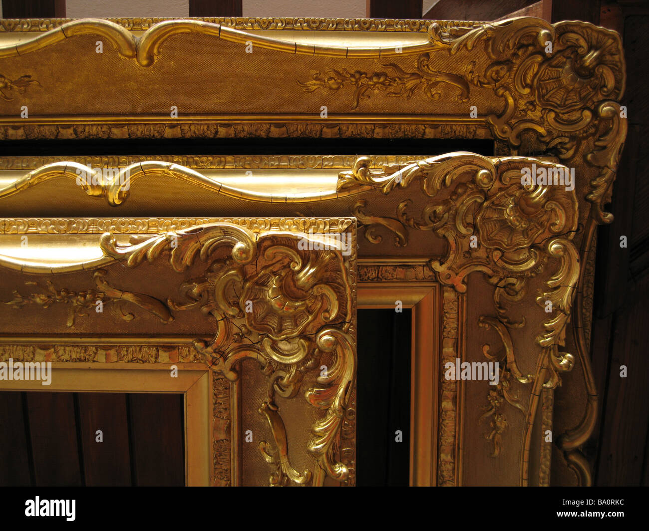Right angle corners of three ornate antique gilded picture frames Stock