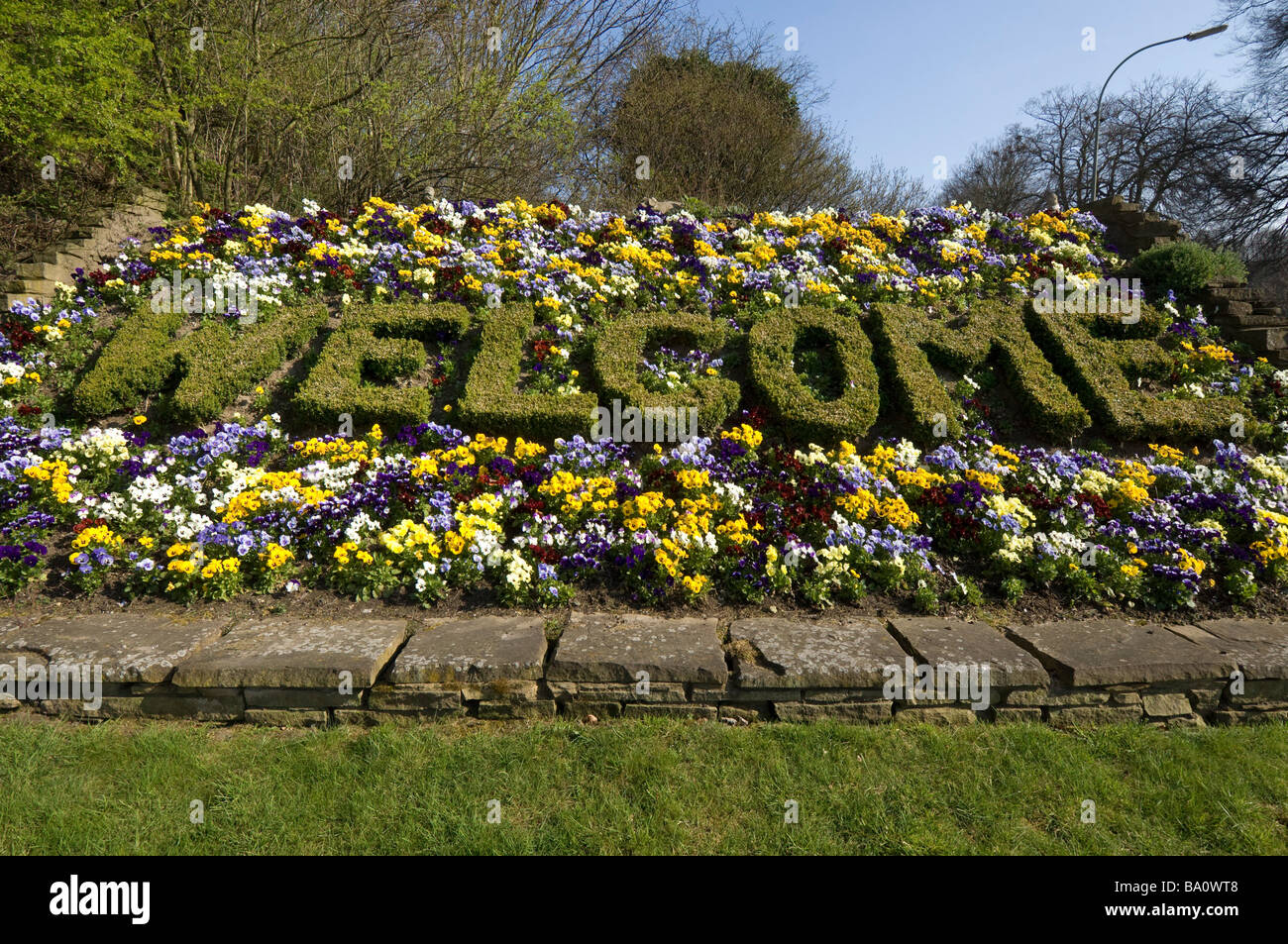 A welcome spelled out in plants greets visitors driving into the city of Brighton and Hove on the A23 road. Stock Photo