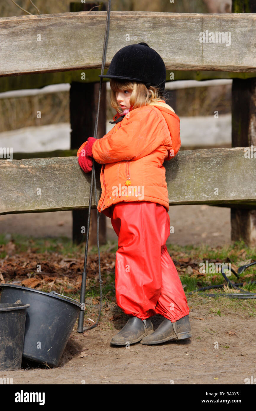 a young girl waiting her turn to ride a pony Stock Photo