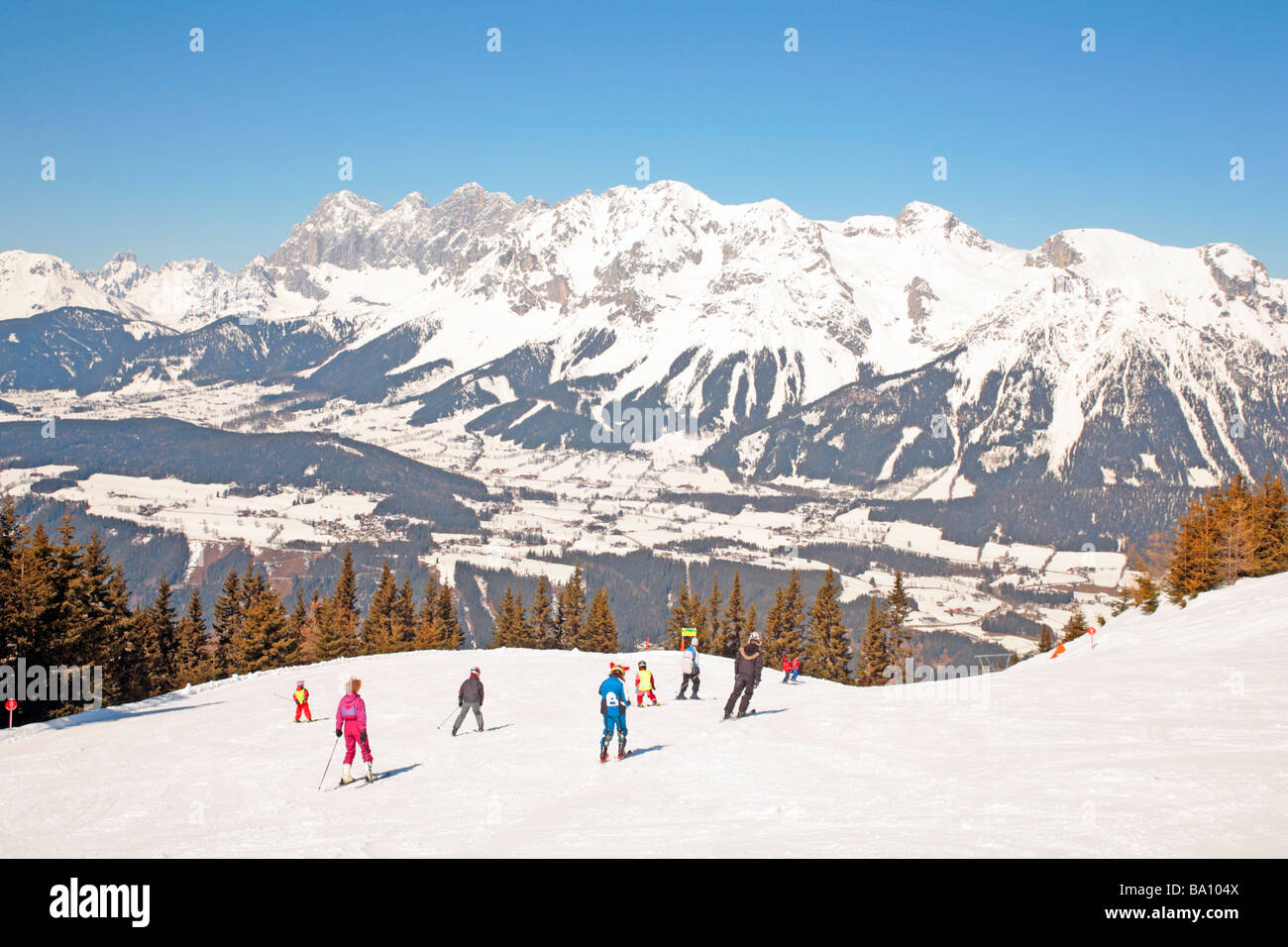 Alpine skiers in front of Dachstein Mountain, Planai, Styria, Austria Stock Photo