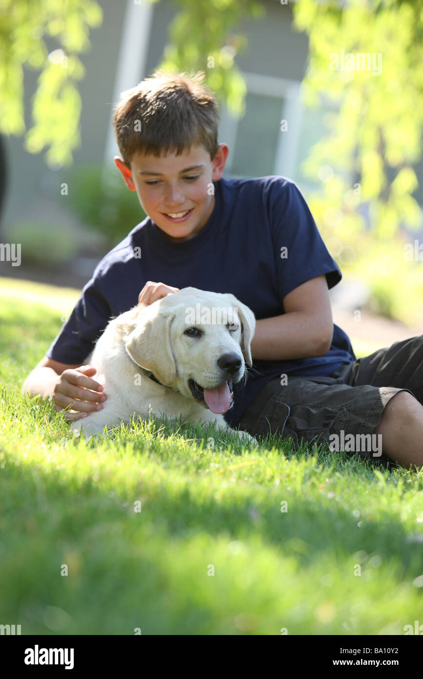 Young boy outdoors with puppy Stock Photo