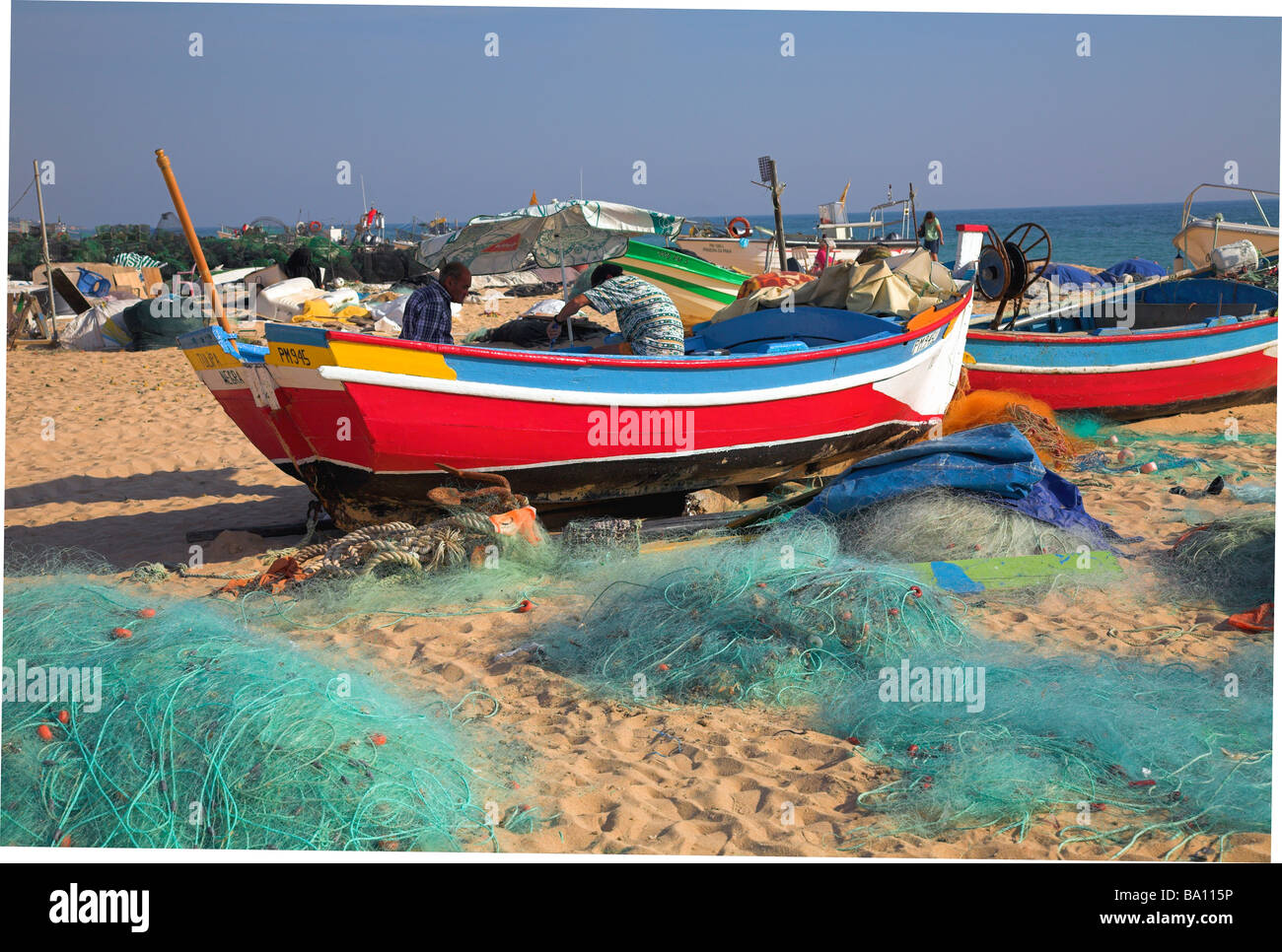 Fishing boats on the beach at Olhos D'Agua, Algarve Stock Photo