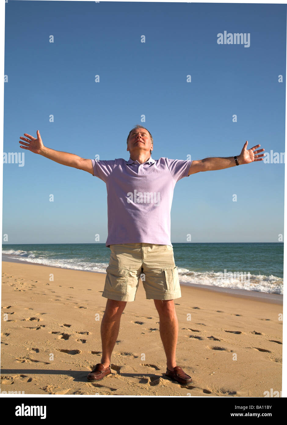 https://c8.alamy.com/comp/BA11BY/man-with-arms-stretched-out-on-beach-BA11BY.jpg
