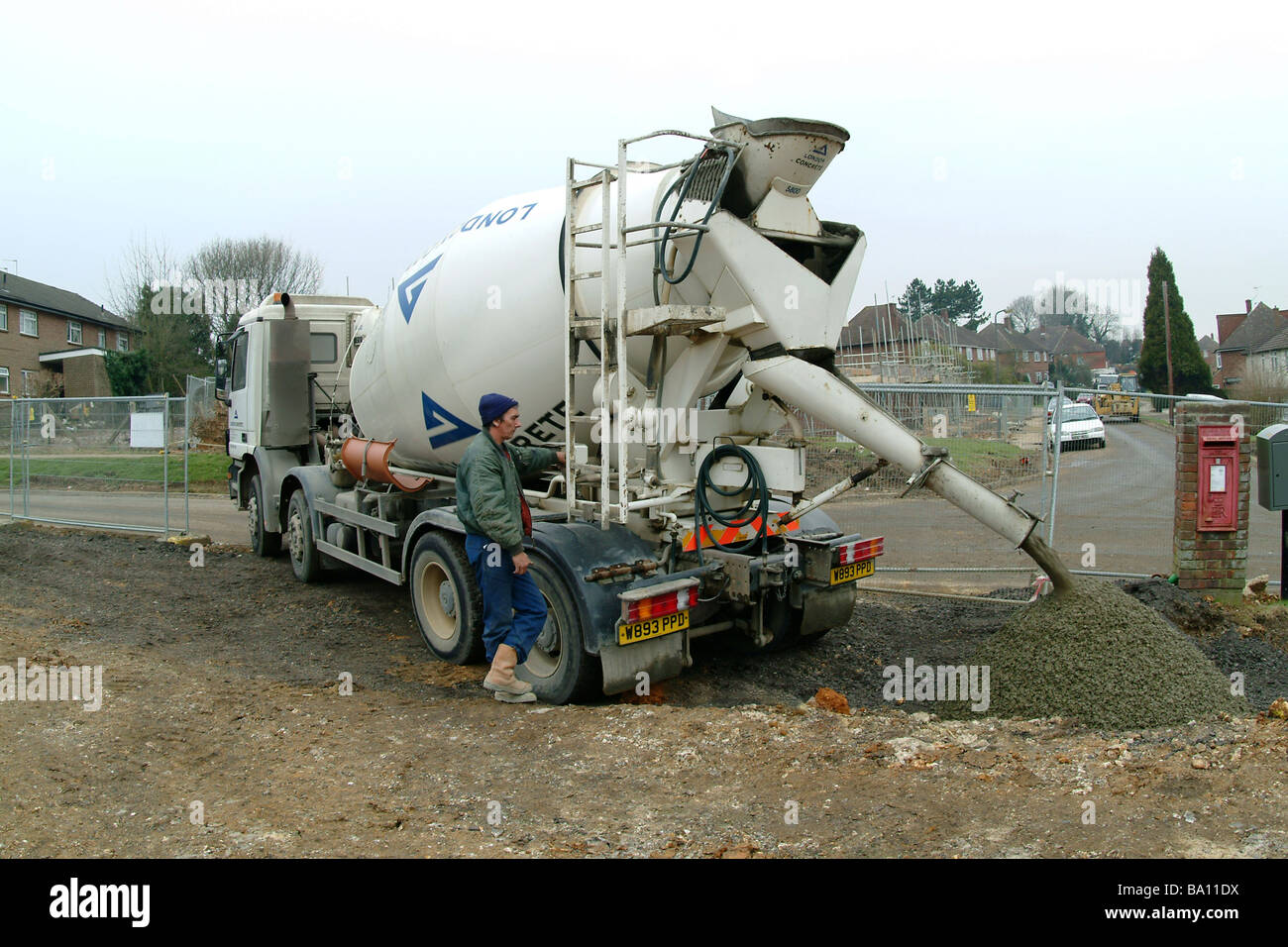 Pouring concrete from a cement mixer on a building site in England