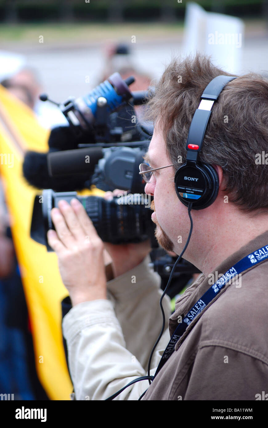 Sound man at a news conference (man wearing headphones) Stock Photo