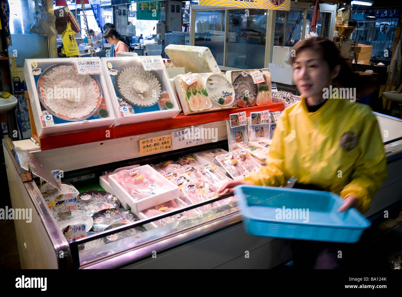 Lady selling fugu (puffer fish) at a market in Shimonoseki, Japan. Fugu is the fish that, if prepared incorrectly, can be poisonous. Stock Photo