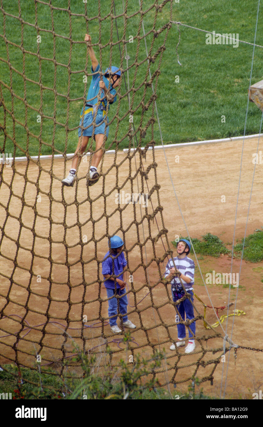 Teen boy climb rope net trust fear confidence safe safety risk skill