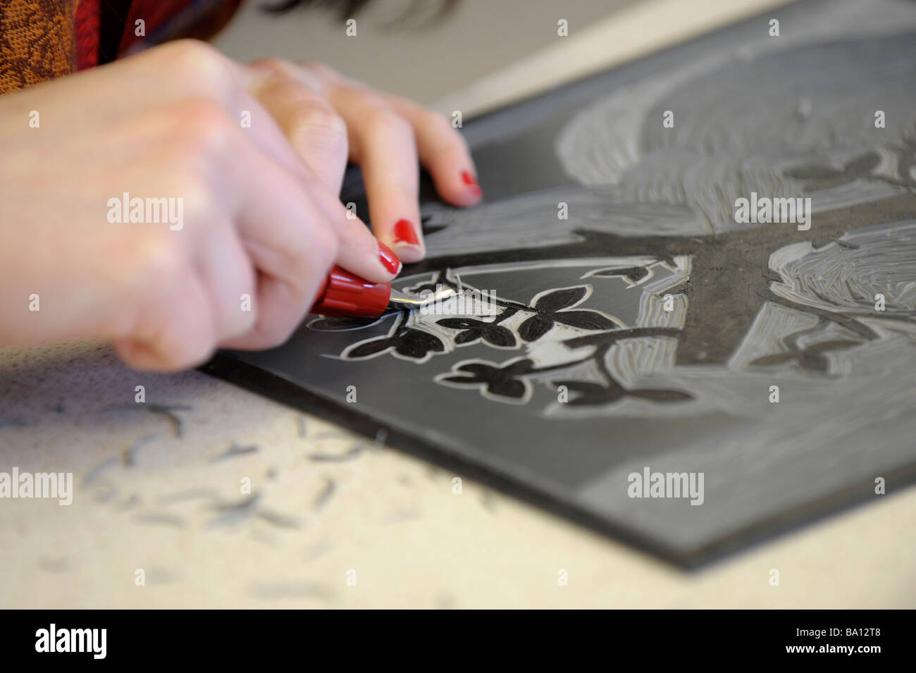 Closeup of hands linocutting in an art class Stock Photo Alamy