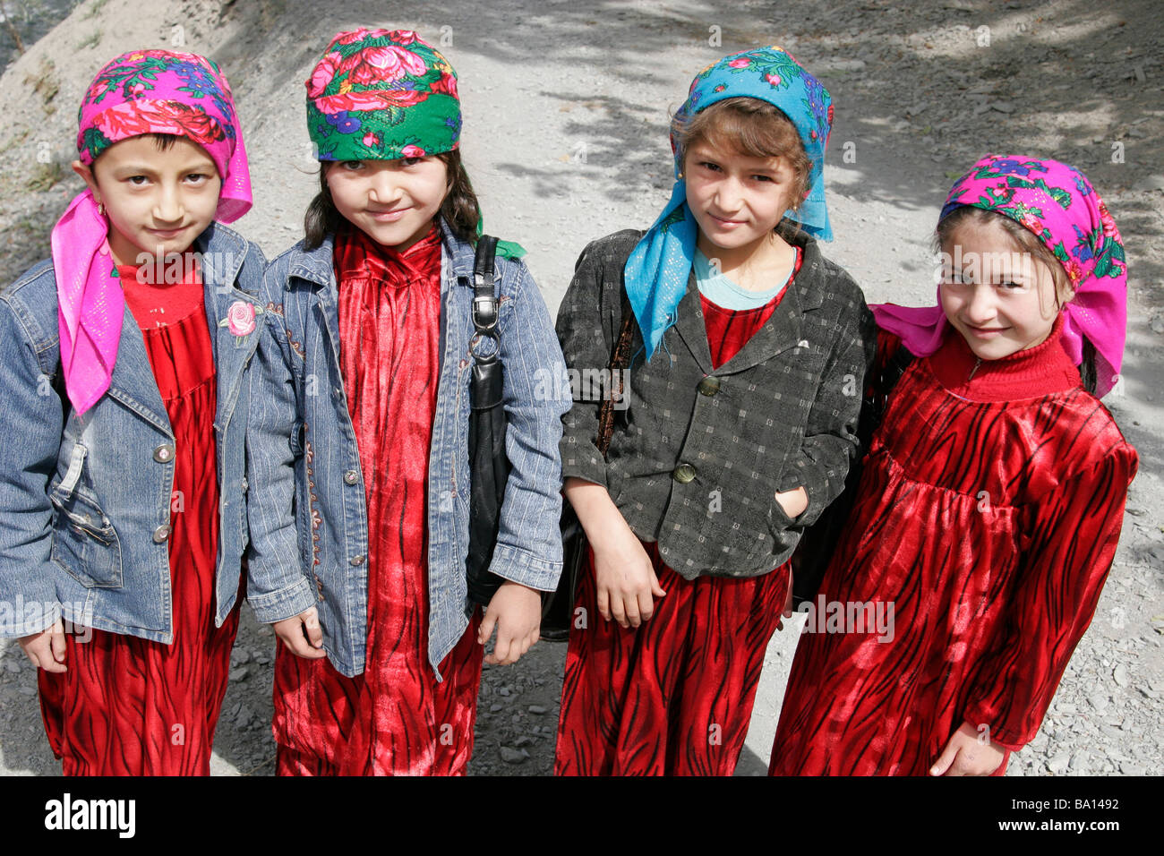Tajik girls wearing traditional dresses and headscarf, Marguzor Lakes, Fan Mountain, Tajikistan, Central Asia Stock Photo