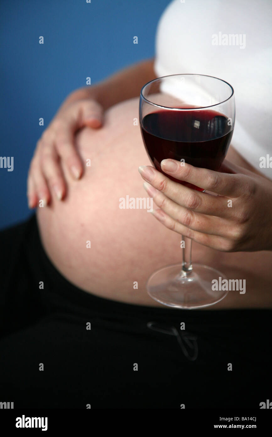 A pregnant woman with a glass of red wine Stock Photo Alamy