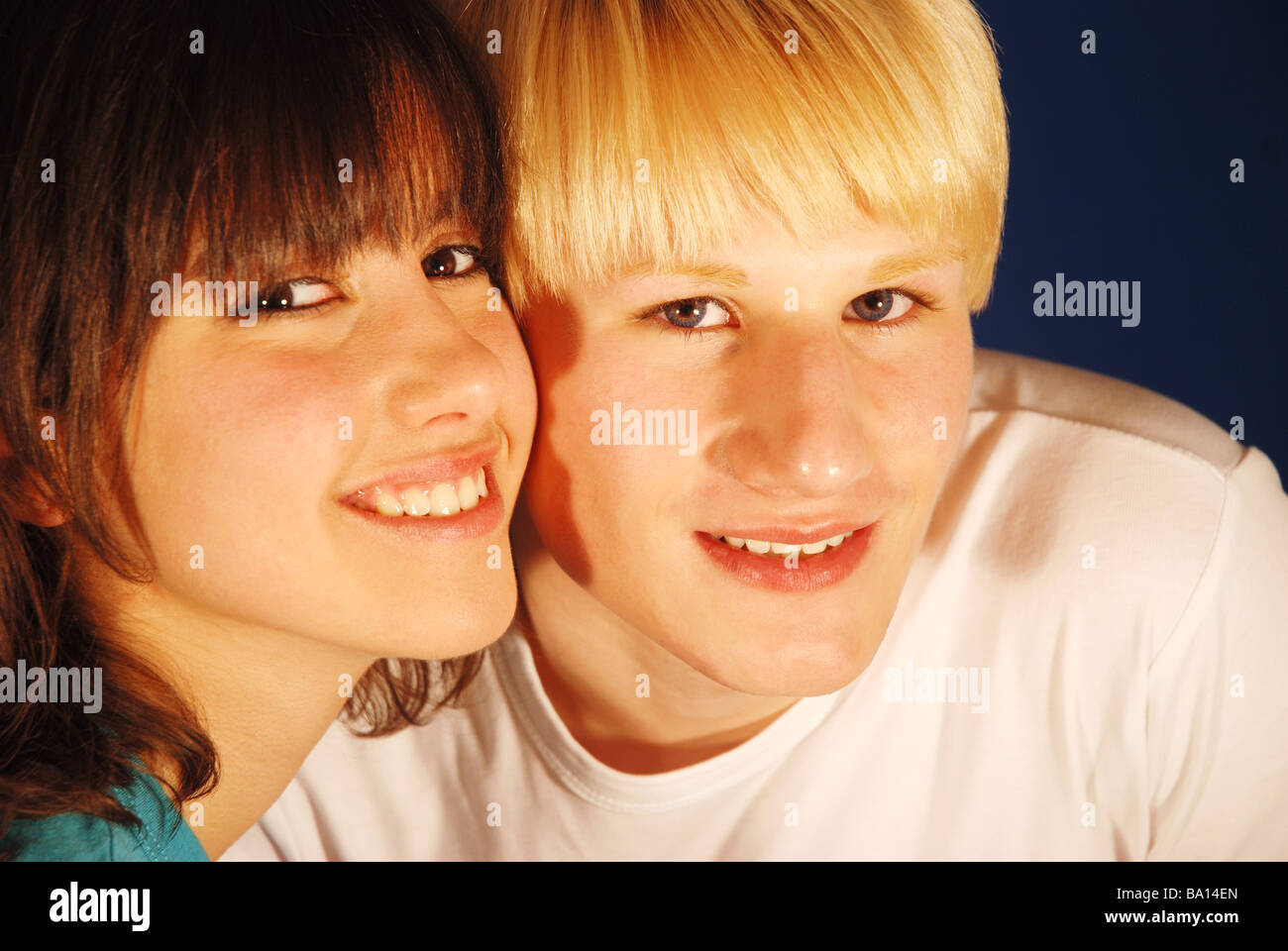Portrait of young couple smiling and looking at the camera. Stock Photo