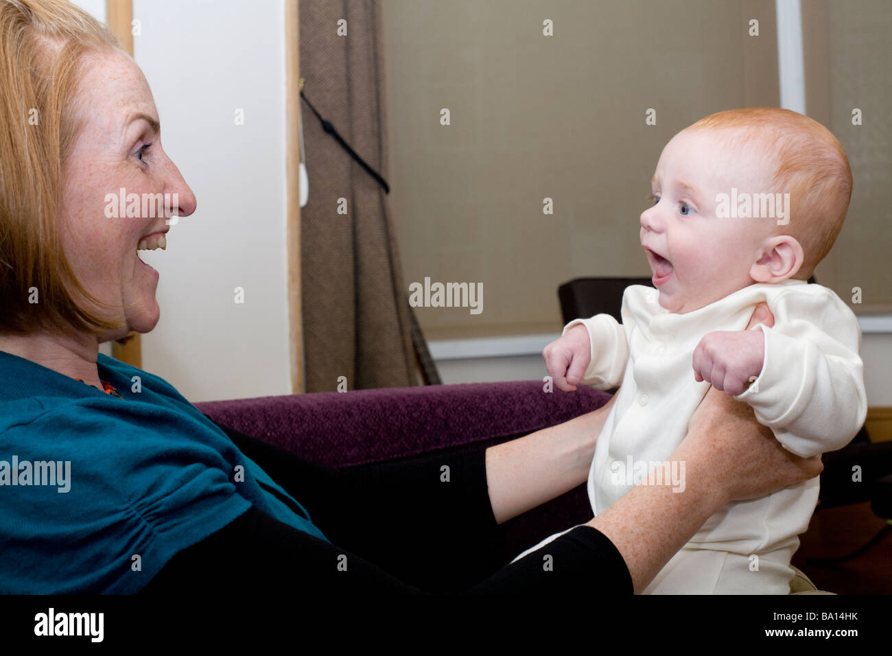Baby bo and mother gleefully play Stock Photo