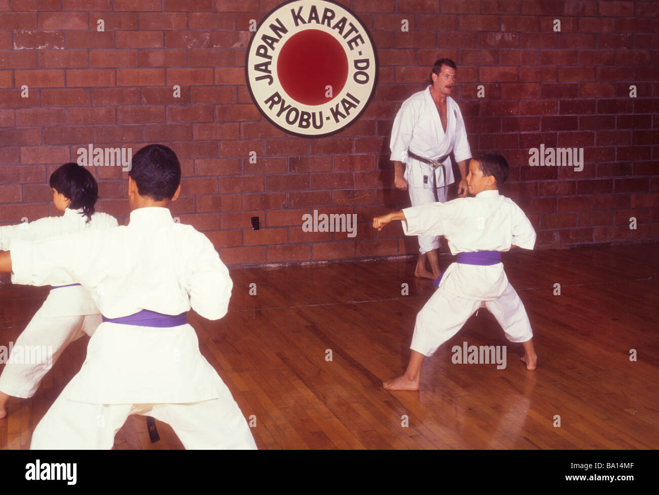 Student karate self defense martial arts sensi dojo class demonstrate show teach learn balance respect exercise Stock Photo
