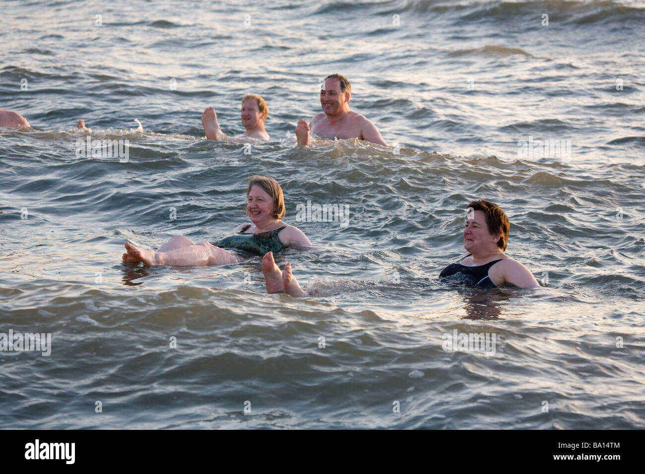 Tourists swimming in the Dead Sea, Jordan Stock Photo