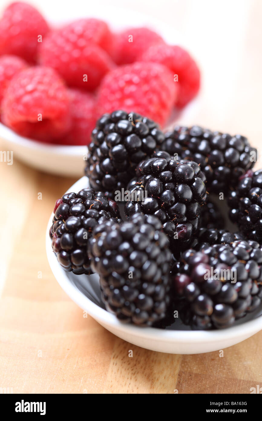 Blackberries and Red Raspberries in small bowls Stock Photo