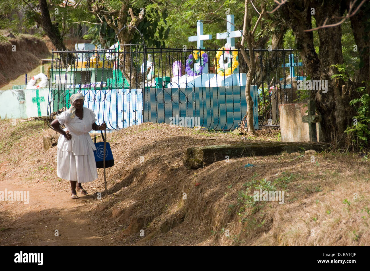 Garifuna woman dressed in white visits the cemetery in Livingston, Guatemala. Stock Photo