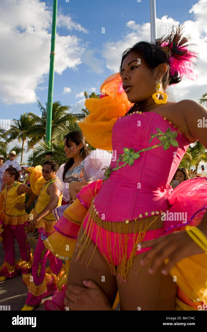 Mexican Girl Wearing Colorful Clothes Is Dancing At The Street Together With Other People Participating At A Fiesta Stock Photo