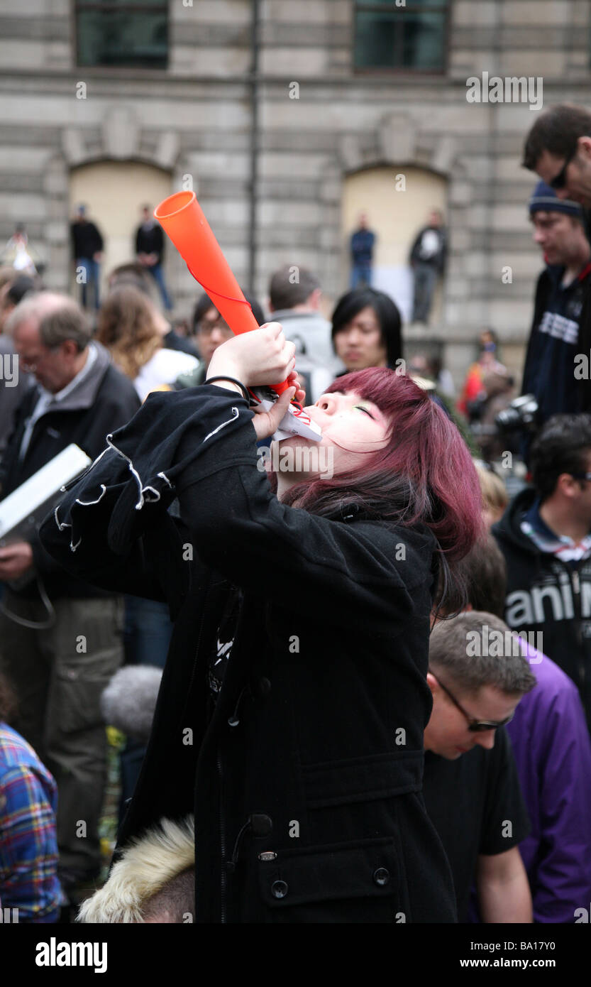 A protestor blowing a horn at the G20 protests in London Stock Photo