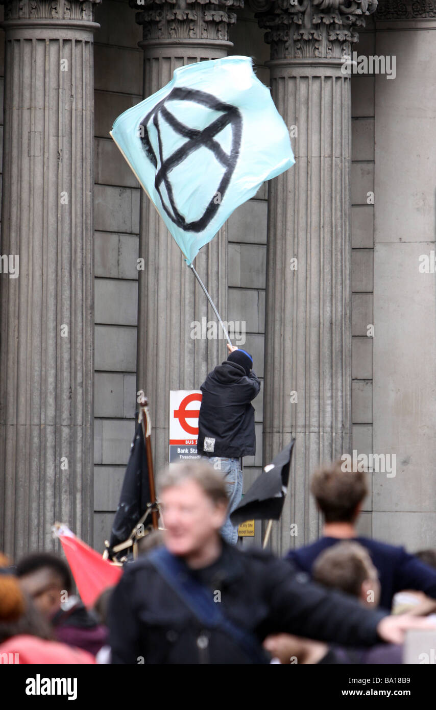 A protestor flying an anarchists flag at the G20 protests in London Stock Photo