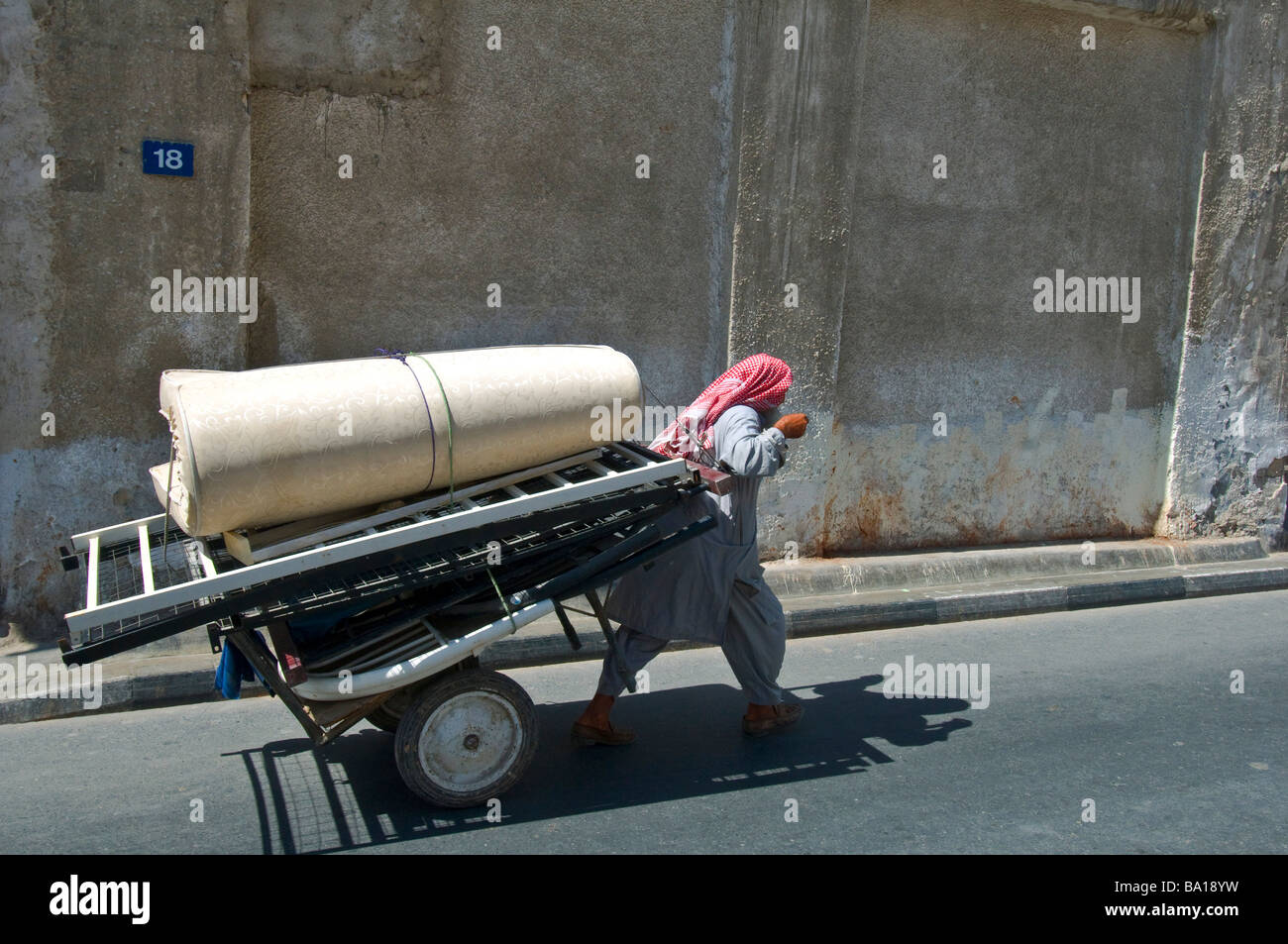 Worker transporting merchandise Dubai Stock Photo