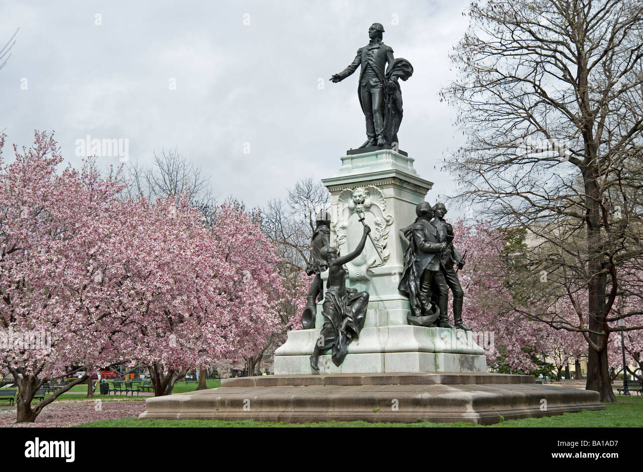 pink Spring flowers bloom near statue by White House Washington DC USA America Stock Photo