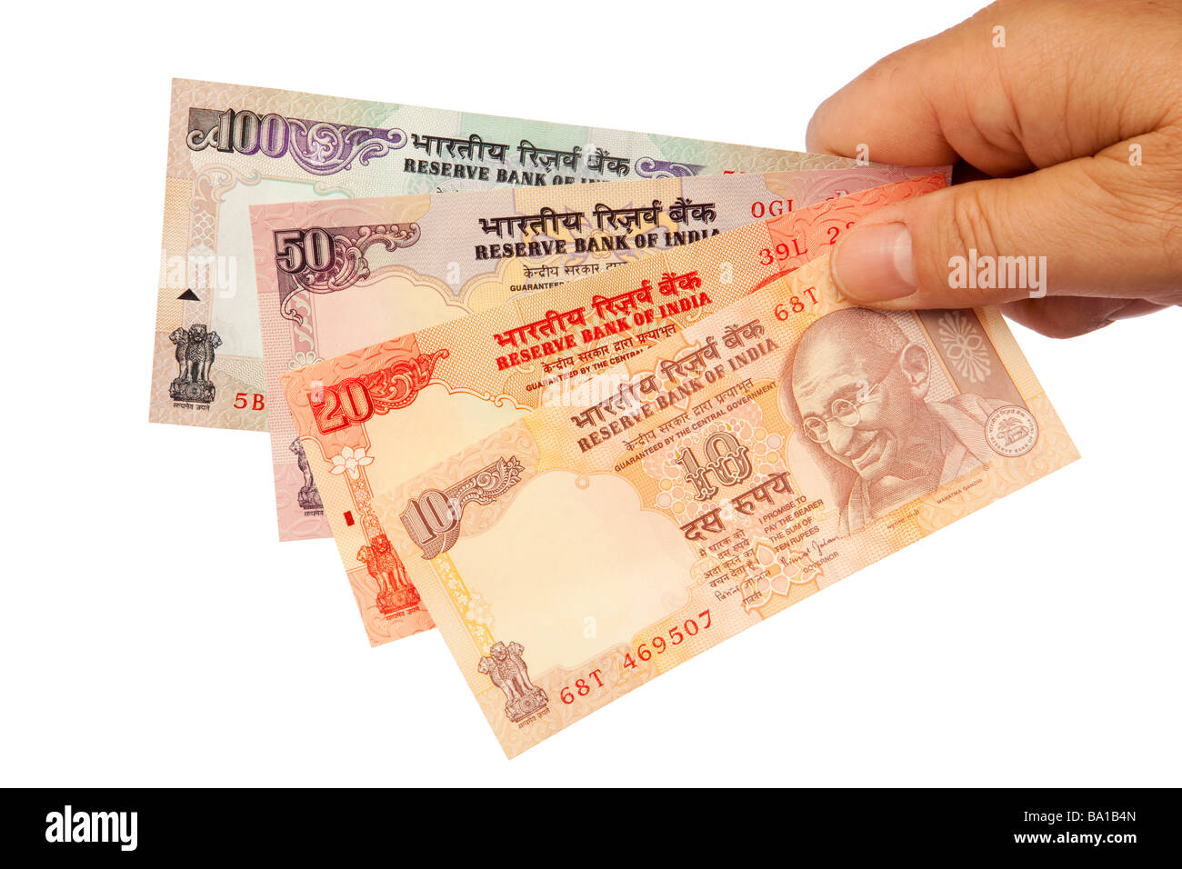 Money male hand holding handful of Indian currency Stock Photo