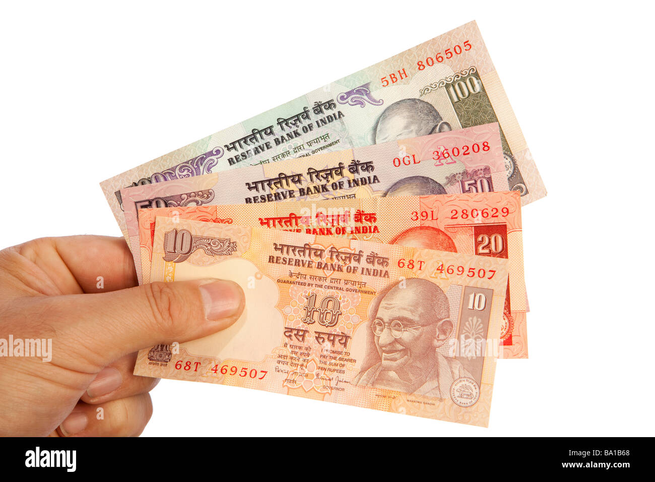 Money male hand holding handful of Indian currency Stock Photo