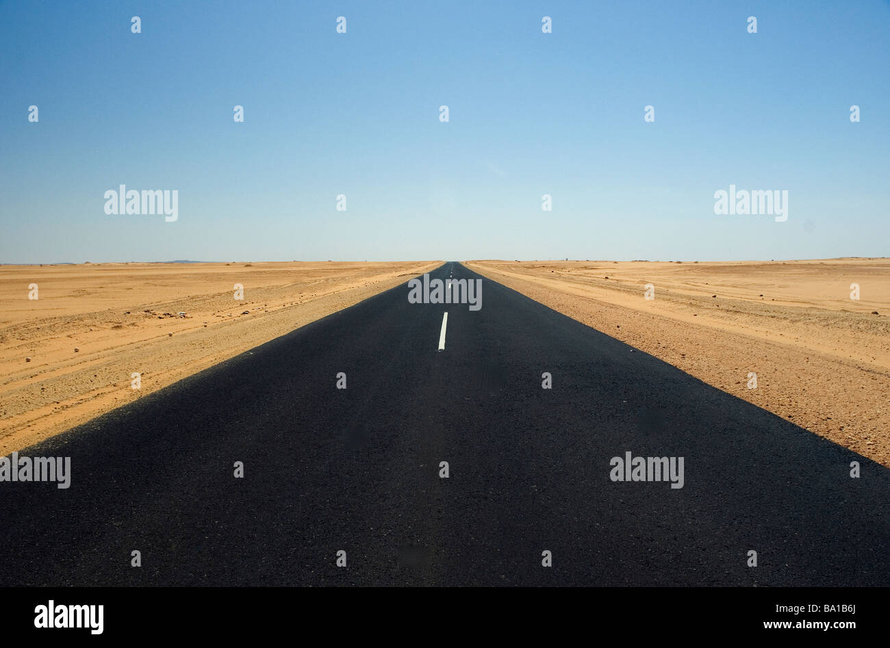 Desert road cutting through the Nubian Desert road Stock Photo
