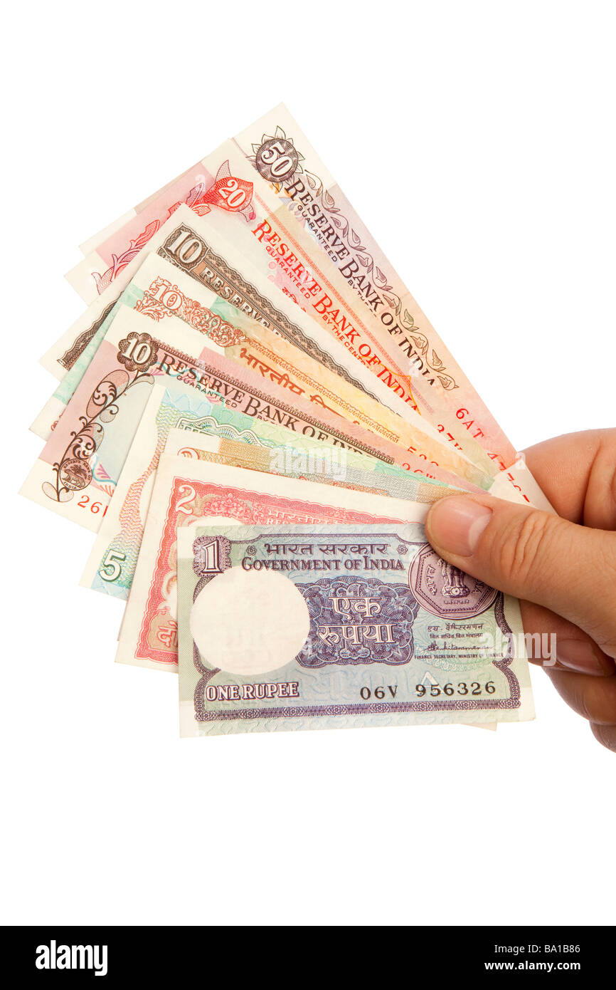 Money male hand holding handful of old Indian currency Stock Photo