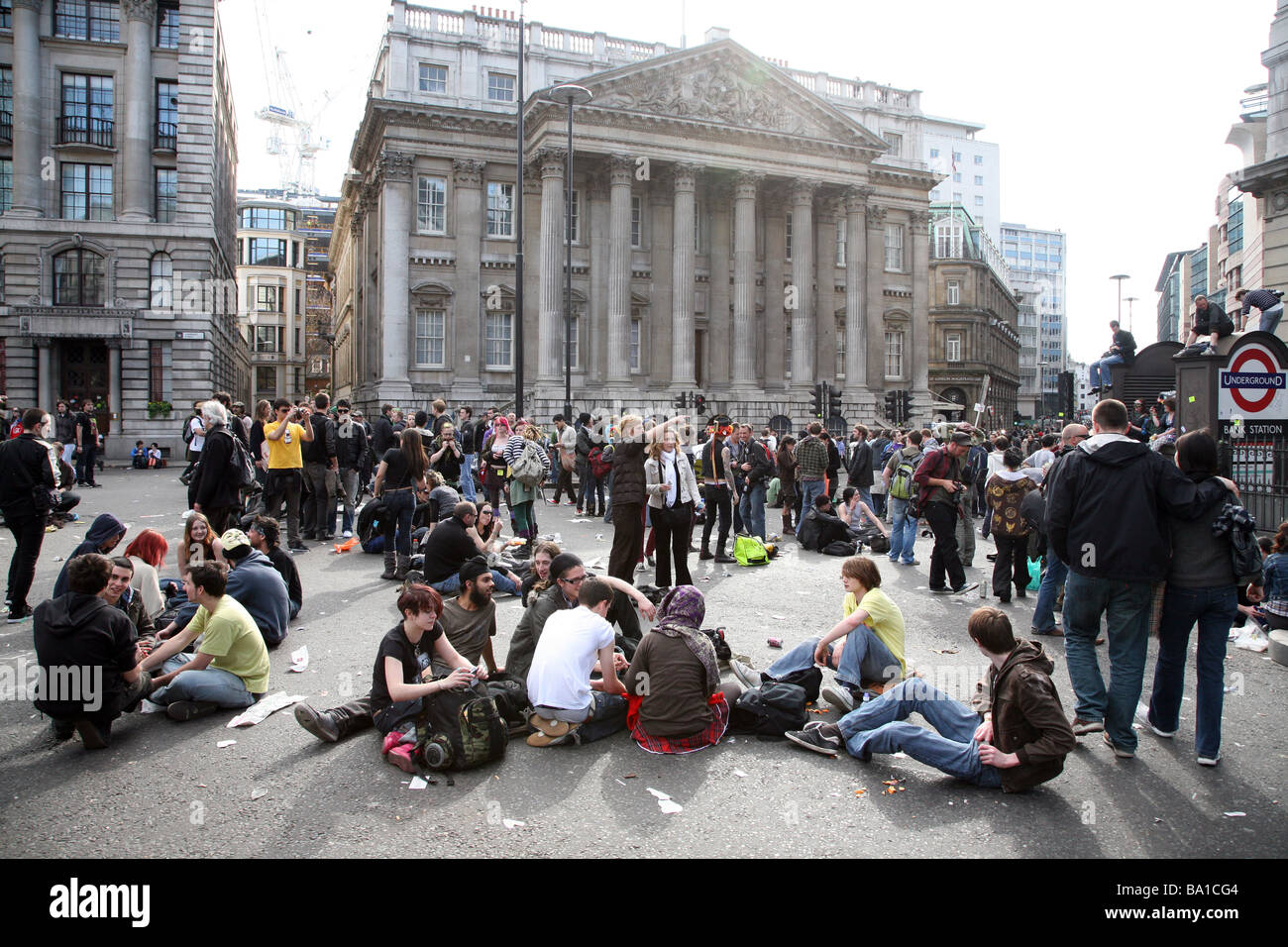 Protestors relaxing in the spring sunshine in front of Mansion House during the G20 protests in London Stock Photo