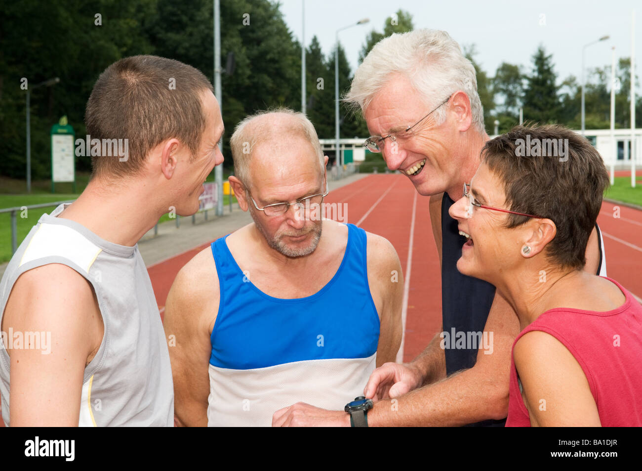 Group of athletes discussing their just finished run Stock Photo - Alamy