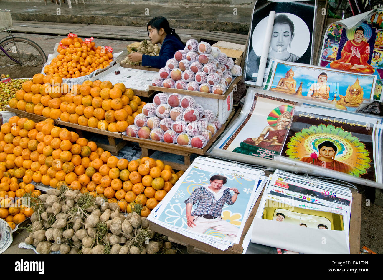 MYANMAR/BURMA. FRUIT AND POSTER VENDOR IN THE MARKET IN KATHA WHERE GEORGE ORWELL S BURMESE DAYS WAS SET Photo Julio Etchart Stock Photo